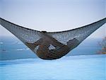 Profile of a young woman relaxing in a hammock