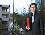 Portrait of a businessman holding a fire extinguisher