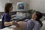 Female doctor performing an ultrasound on a pregnant woman