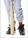 Low section view of a baseball player holding a baseball bat