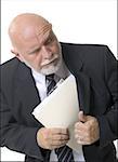 Close-up of a businessman putting papers inside his coat