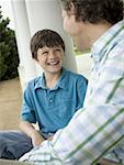 Close-up of a boy and his father smiling