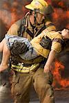 Firefighter carrying an injured boy