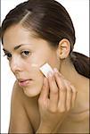 Close-up of a woman applying liquid makeup