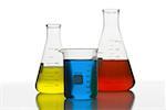 Close-up of beakers with colored liquid