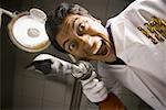 Dentist with drill dramatic angle