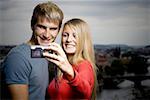 Close-up of a young man and a young woman photographing themselves
