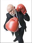 High angle view of a businessman wearing boxing gloves