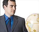 Close-up of a businessman looking at the globe