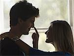 Silhouette of a teenage couple looking at each other