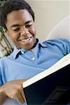 Close-up of a teenage boy reading a book