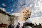 Close-up of a businessman getting hosed