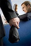 Close-up of a man's hand holding an umbrella