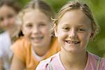 Close-up of three girls sitting together