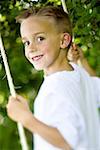 Portrait of a boy swinging on a swing