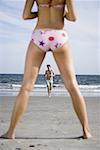 Rear view of a young woman standing on the beach