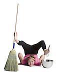 Female contortionist sweeping and mixing