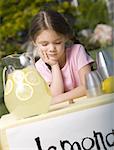 Close-up of a girl looking at a stack of coins and thinking