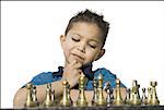 Close-up of a boy playing chess