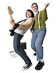Young man with electric guitar and young nerd playing air guitar