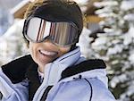 Woman with ski goggles outdoors in winter