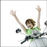 Portrait of a teenage girl sitting on a scooter with her arms raised
