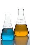 Close-up of beakers on a table in a laboratory with colored liquid
