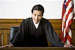 Portrait of a female judge leaning against a bench