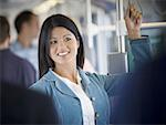 Close-up of an adult woman standing on a commuter train