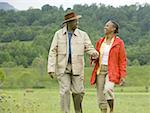 Senior man and a senior woman walking in a field