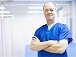 Portrait of a male doctor smiling with his arms crossed