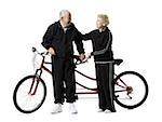 Older couple riding a tandem bicycle