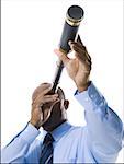 Businessman looking through telescope