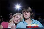 Girl crying at movie theater with boy and popcorn