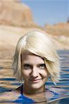 Portrait of a young woman swimming in a lake