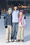 Three girls with skates outdoors in winter smiling