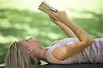 Close-up of a young woman reading a book in a park