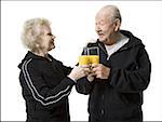 Older couple in track suits taking a juice break