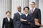 Portrait of  lawyers smiling in front of a courthouse