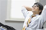 Close-up of a businessman leaning back in his chair