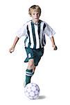 Portrait of a boy dribbling a soccer ball