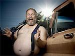 Overweight man with suspenders by truck