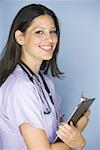 Side profile of a female nurse holding a clipboard