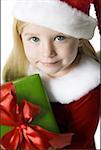 Portrait of a girl holding a Christmas present