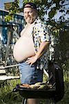 Overweight man in inflatable wading pool - Stock Photo - Masterfile