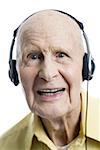 Portrait of a senior man listening to music on headphones