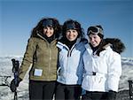 Three women outdoors in winter skiing