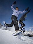 Low angle view of two women on snowshoes