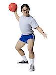 Portrait of a young man getting hit with a dodgeball