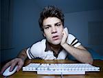Man with hand on mouse and keyboard watching